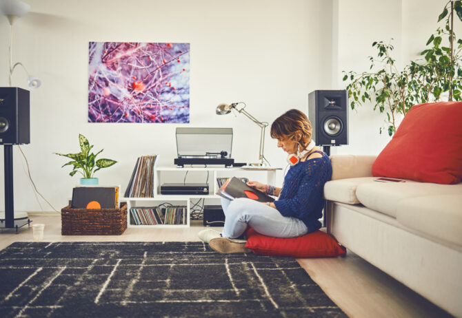 Woman listening vinyl at home