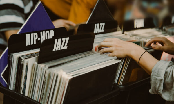 Woman is choosing a vinyl record in a musical store