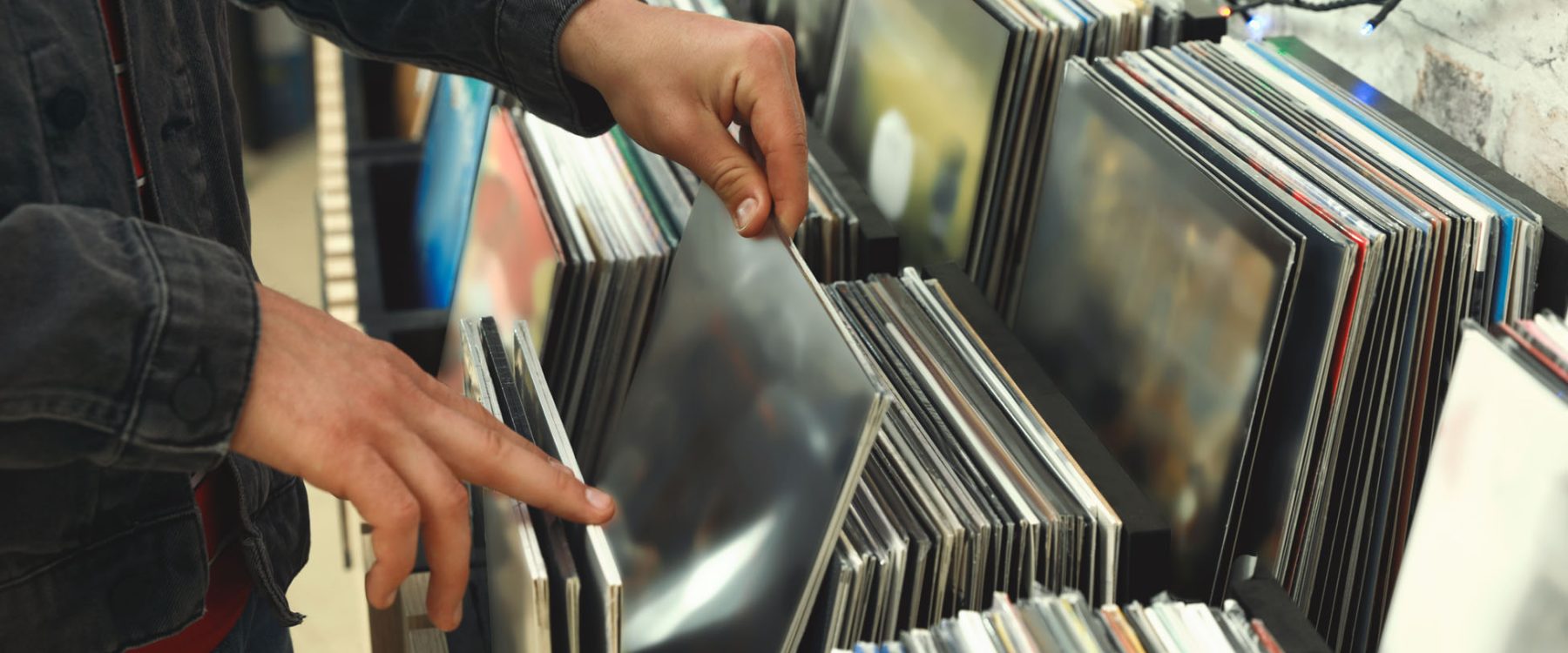 Man choosing vinyl records in store, closeup